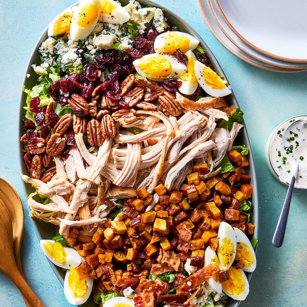 thanksgiving cobb salad with shredded turkey, sweet potatoes, bacon, hardboiled eggs, blue cheese, pecans, and cranberries