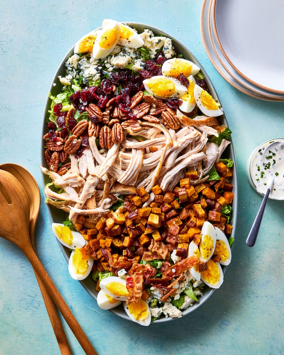 thanksgiving cobb salad with shredded turkey, sweet potatoes, bacon, hardboiled eggs, blue cheese, pecans, and cranberries