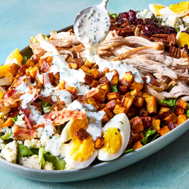 thanksgiving cobb salad with shredded turkey, sweet potatoes, bacon, hardboiled eggs, blue cheese, pecans, and cranberries