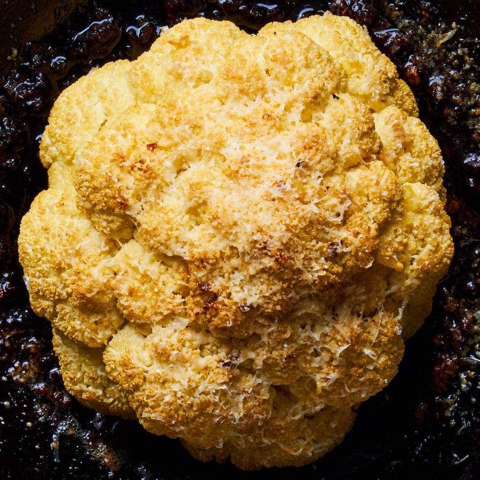 whole roasted cauliflower in a cast iron skillet
