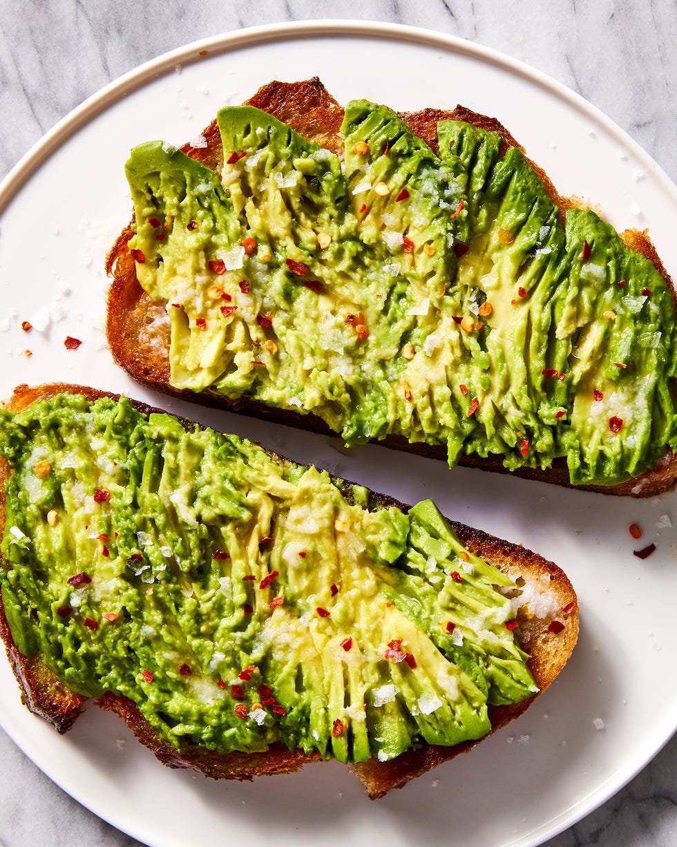 olive oil toasted whole wheat sourdough bread topped with ripe avocado, garlic, lemon juice, and red pepper flakes avocado toast