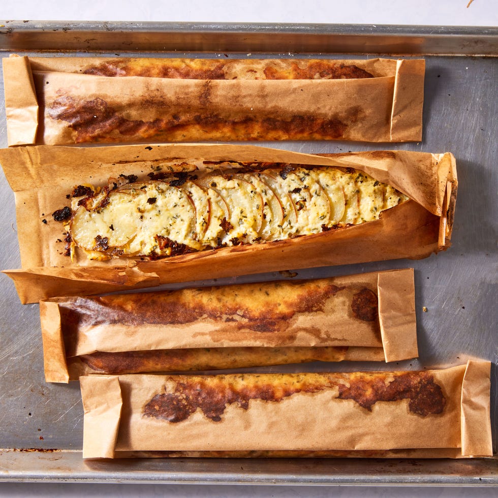 thinly sliced red potatoes layered with herby cream cheese, parmesan, and gruyere and baked in a parchment pouch