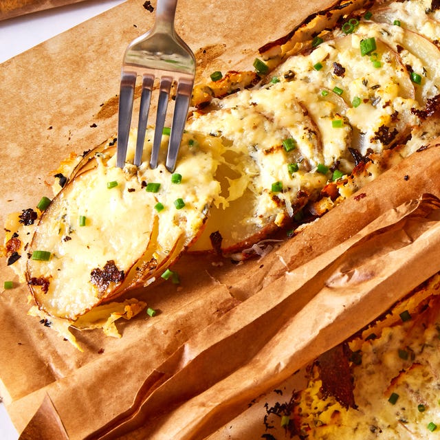 Potato Gratin Bundles thinly sliced potatoes layered with herbed garlicky cream cheese, gruyere, and parmesan, then roasted in a parchment pouch
