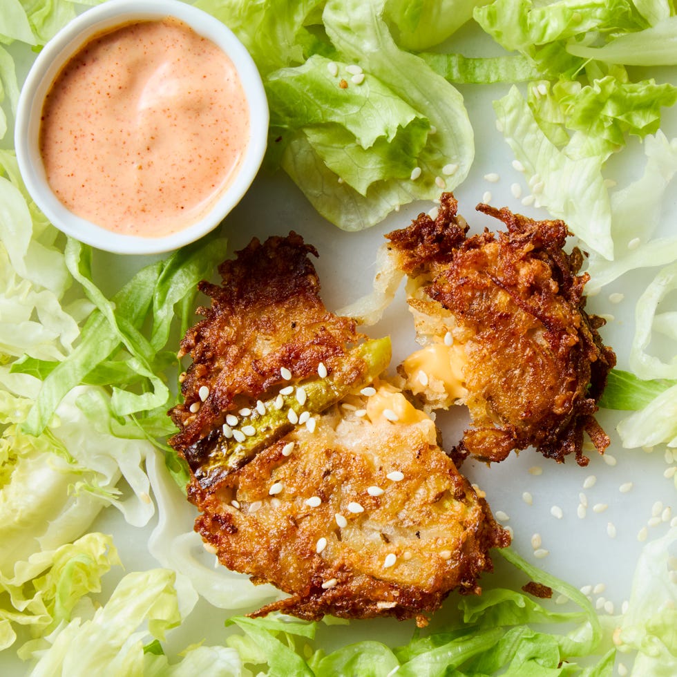 big mac latke in a field of iceberg lettuce with a bowl of big mac sauce
