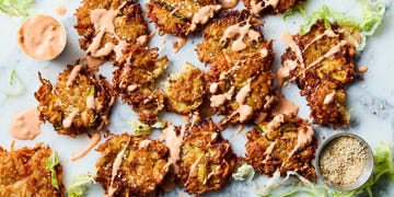 big mac latkes drizzled with big mac sauce with a bowl of big mac sauce and iceberg lettuce