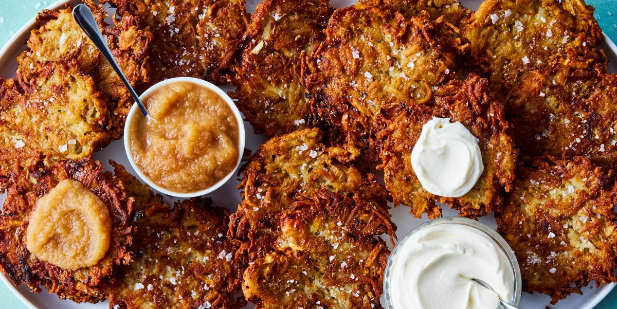 Latkes crispy latkes on a platter with bowls of sour cream and applesauce