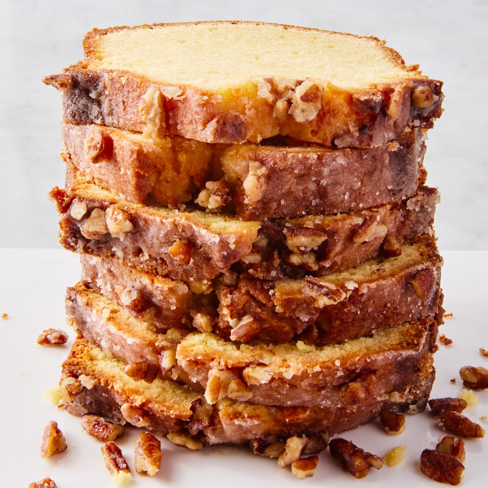 a loaf of pound cake topped with a rum infused glaze and chopped walnuts