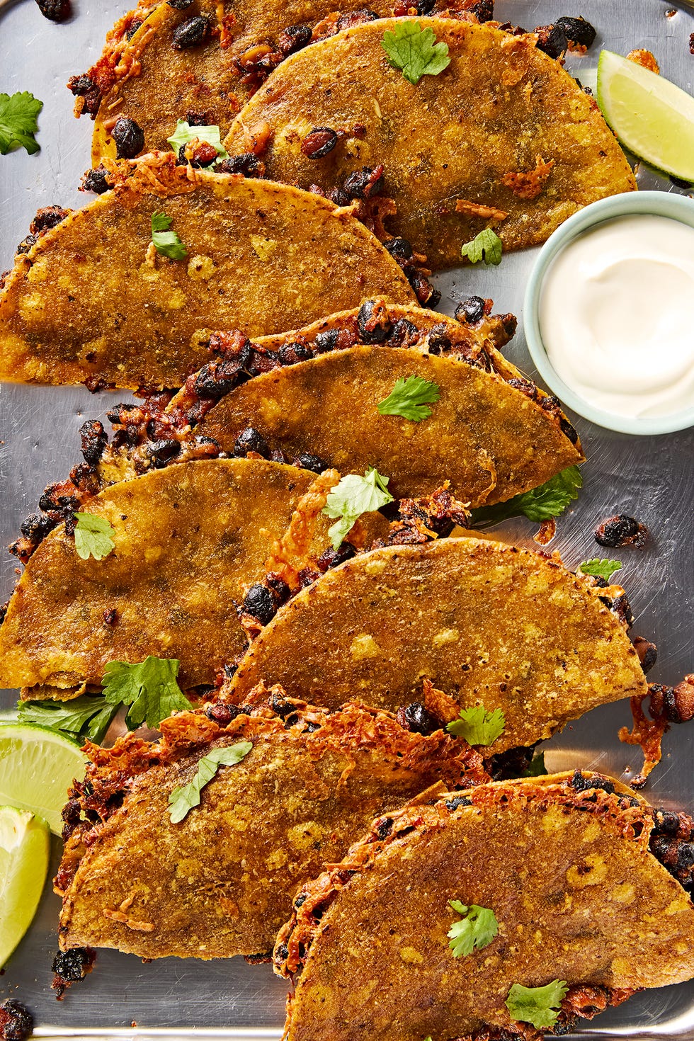 Crispy sheet pan black bean tacos crispy sheet pan black bean tacos on a sheet pan with a bowl of sour cream