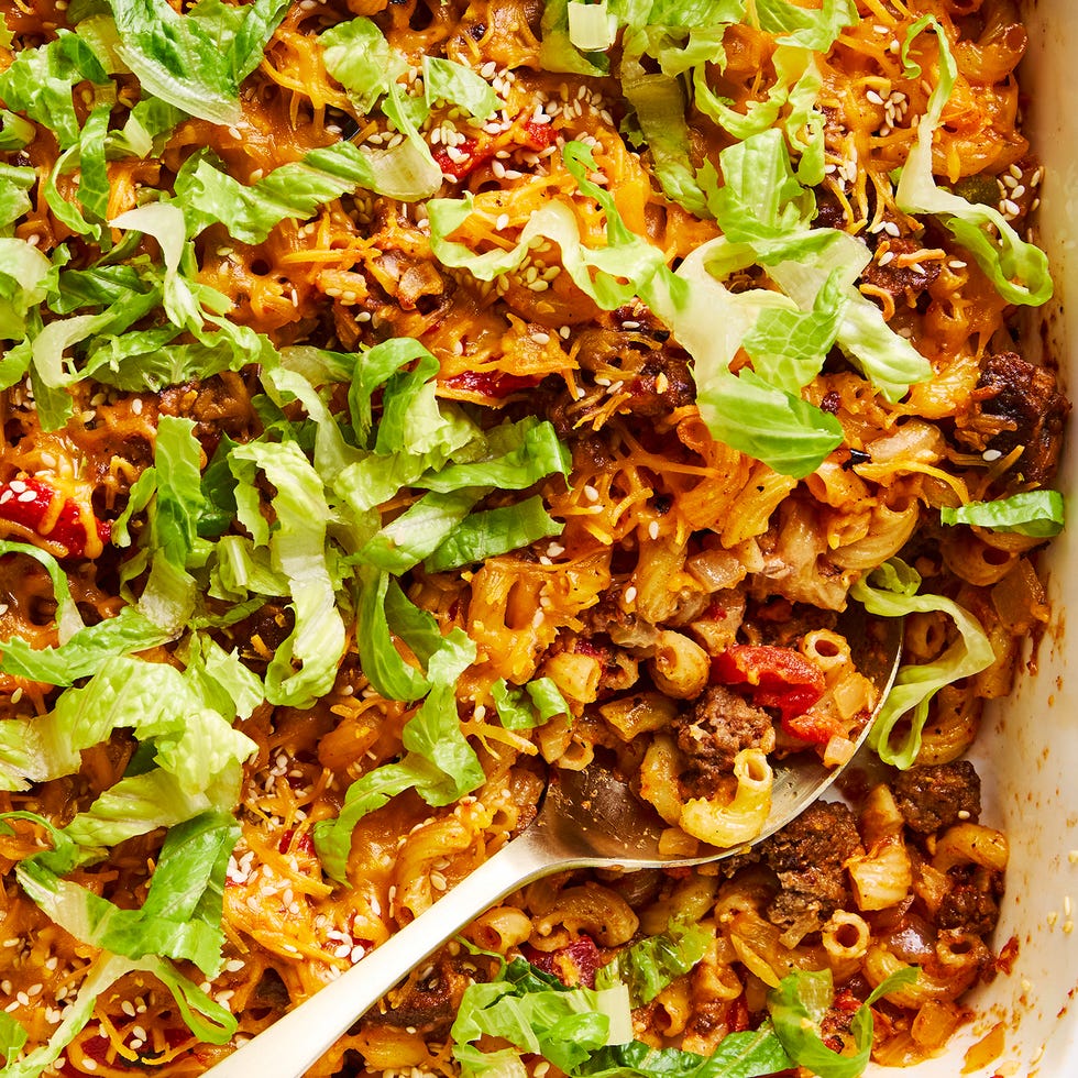 a casserole dish filled with elbow macaroni, ground beef, and a creamy sauce