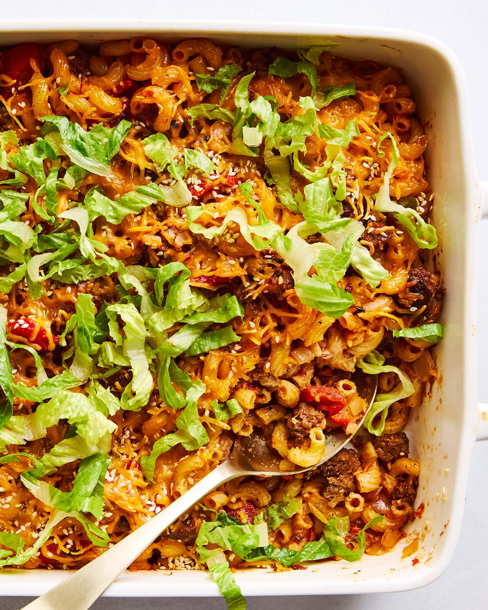 a casserole dish filled with elbow macaroni, ground beef, and a creamy sauce