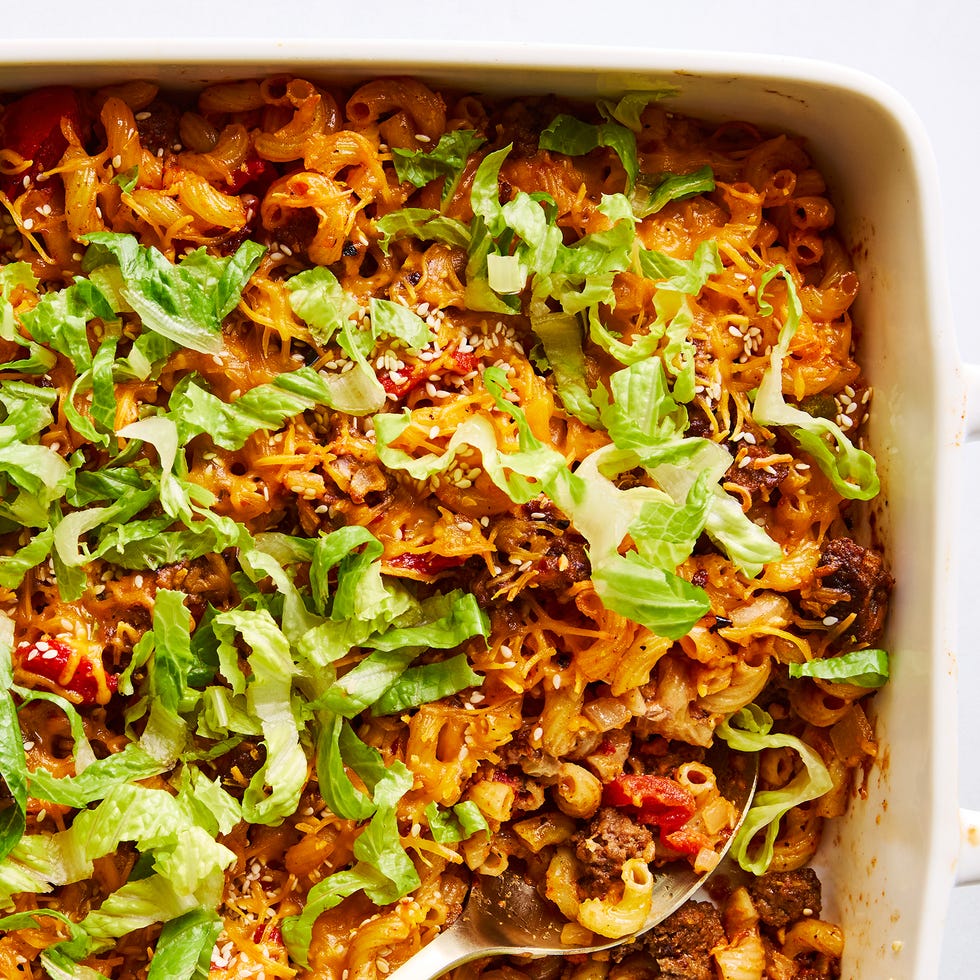 a casserole dish filled with elbow macaroni, ground beef, and a creamy sauce