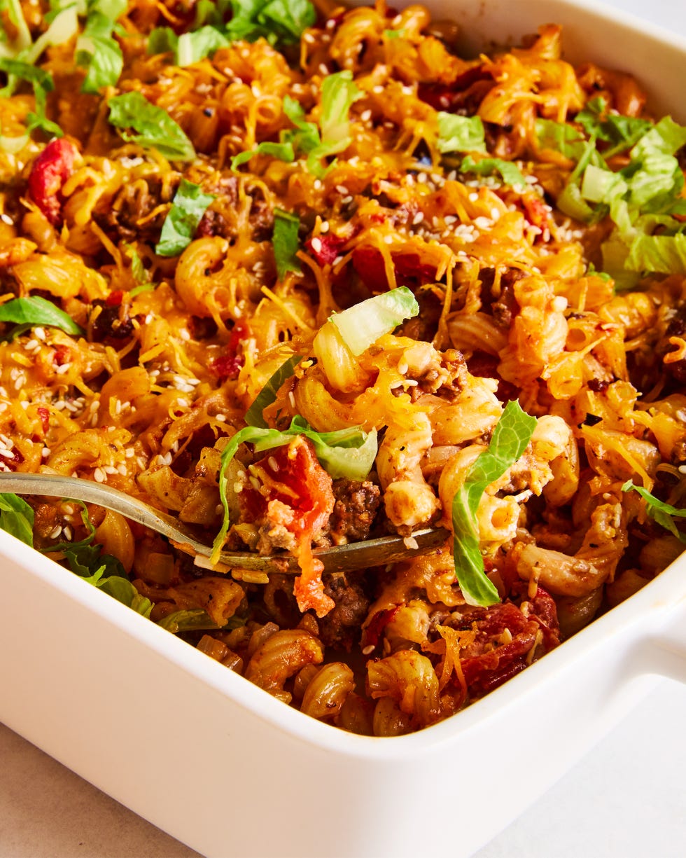 a casserole dish filled with elbow macaroni, ground beef, and a creamy sauce