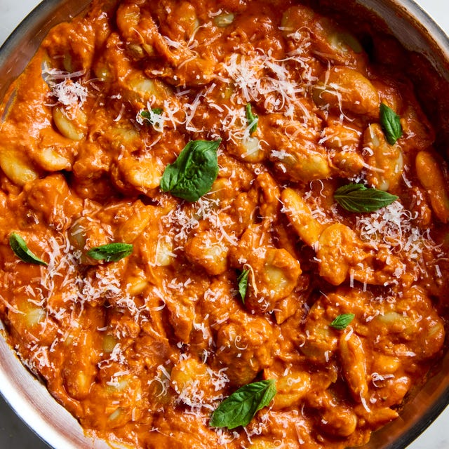 butter beans alla vodka topped with parmesan and basil in a pan