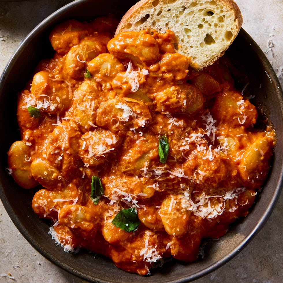 butter beans alla vodka in a bowl with crispy bread