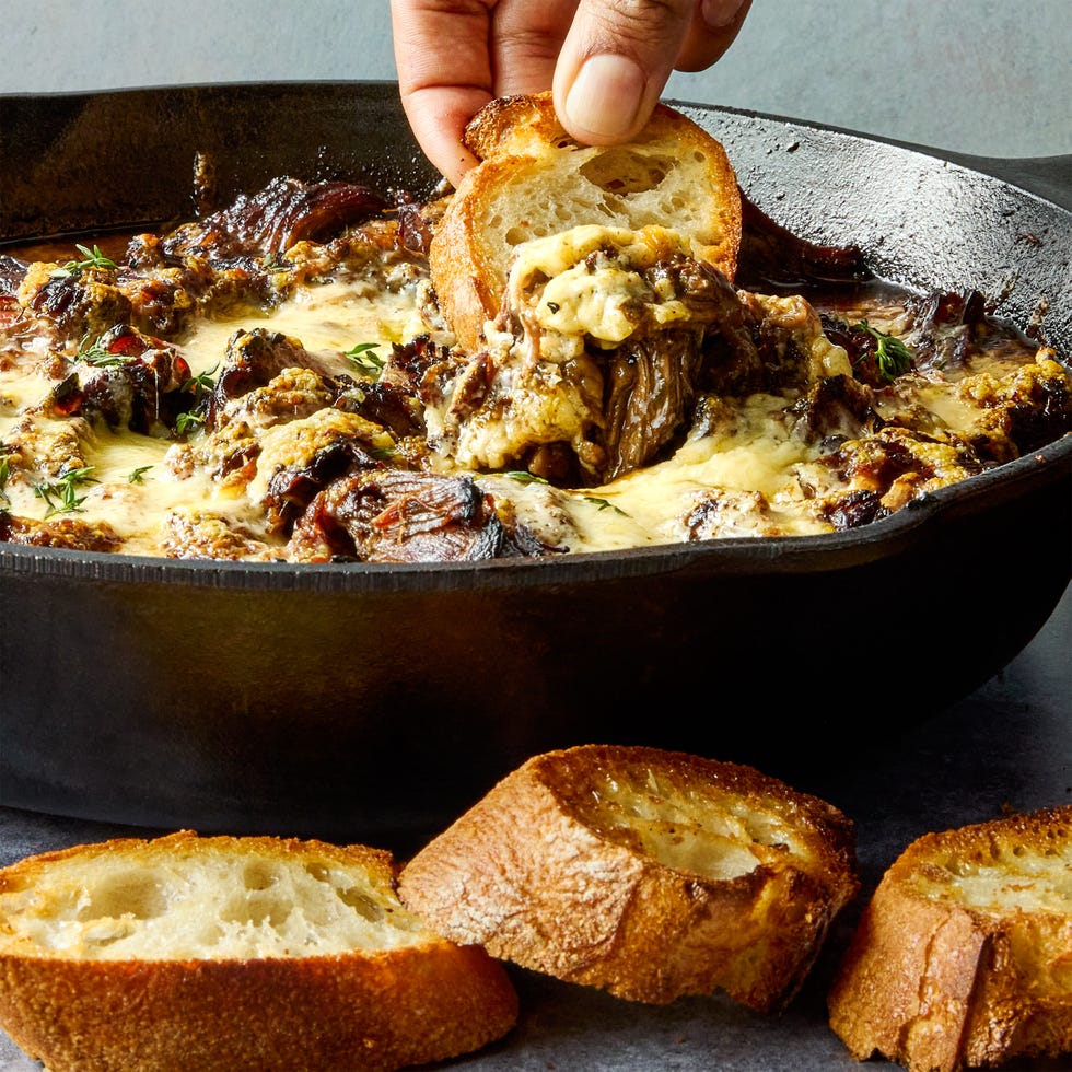 onion seasoned beef is nestled in a bed of cooked onions, red wine, fresh thyme, and beef broth, then braised until ridiculously tender, shredded, and topped with nutty, salty gruyere cheese