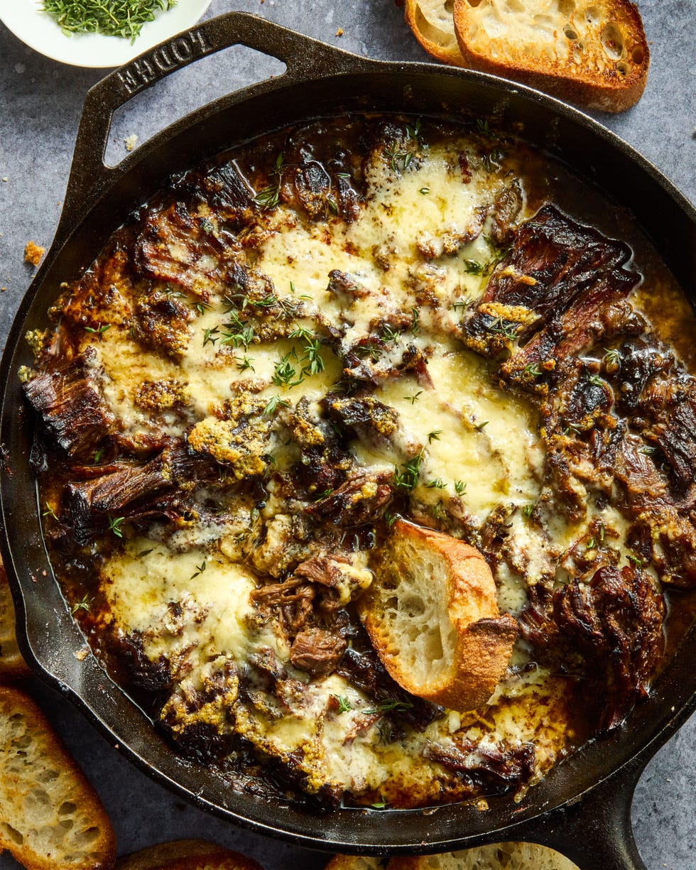 onion seasoned beef is nestled in a bed of cooked onions, red wine, fresh thyme, and beef broth, then braised until ridiculously tender, shredded, and topped with nutty, salty gruyere cheese