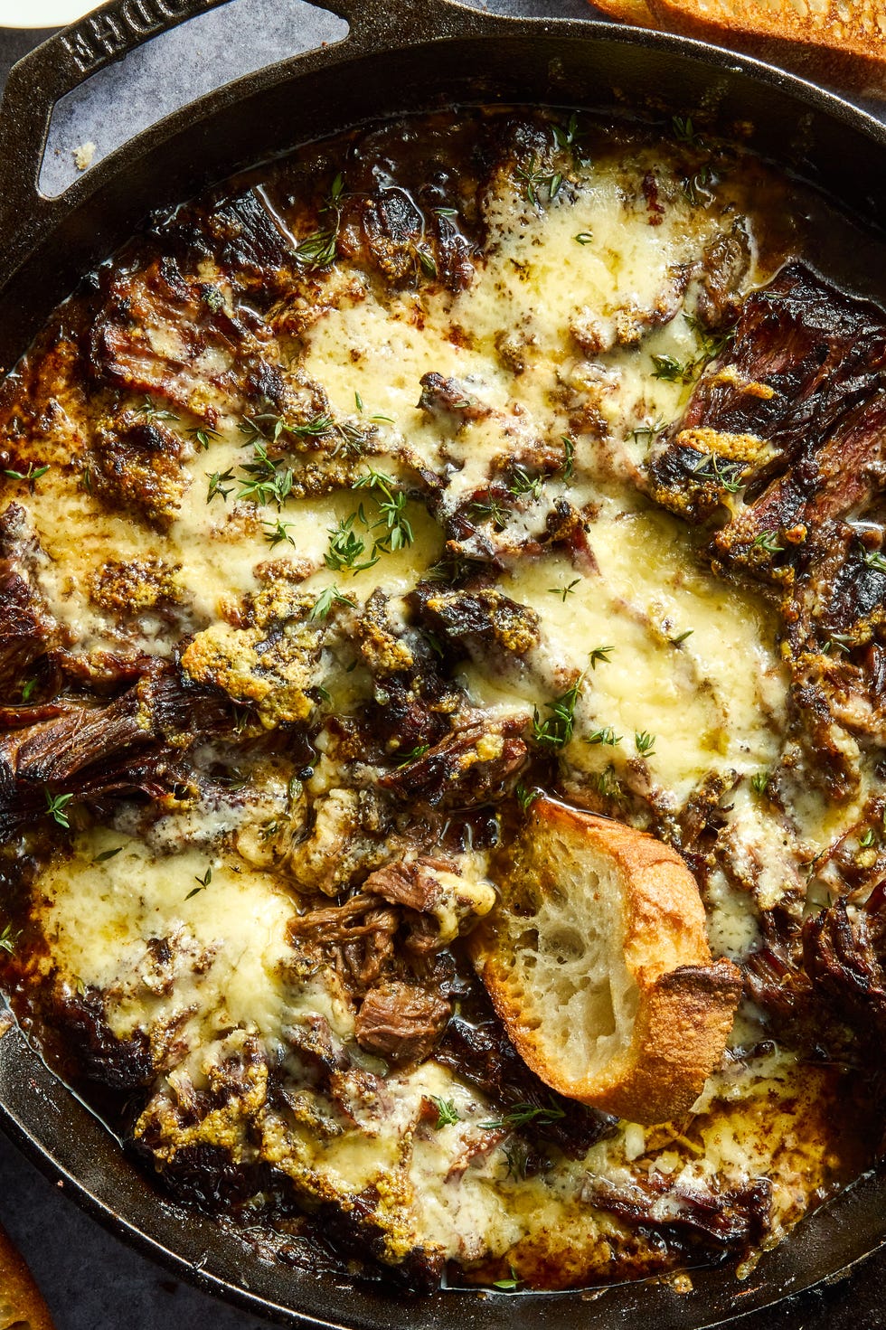 French Onion Pot Roast onion seasoned beef is nestled in a bed of cooked onions, red wine, fresh thyme, and beef broth, then braised until ridiculously tender, shredded, and topped with nutty, salty gruyere cheese