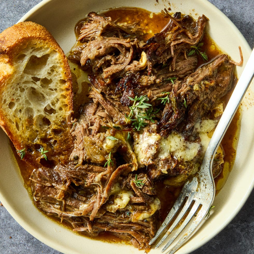 onion seasoned beef is nestled in a bed of cooked onions, red wine, fresh thyme, and beef broth, then braised until ridiculously tender, shredded, and topped with nutty, salty gruyere cheese