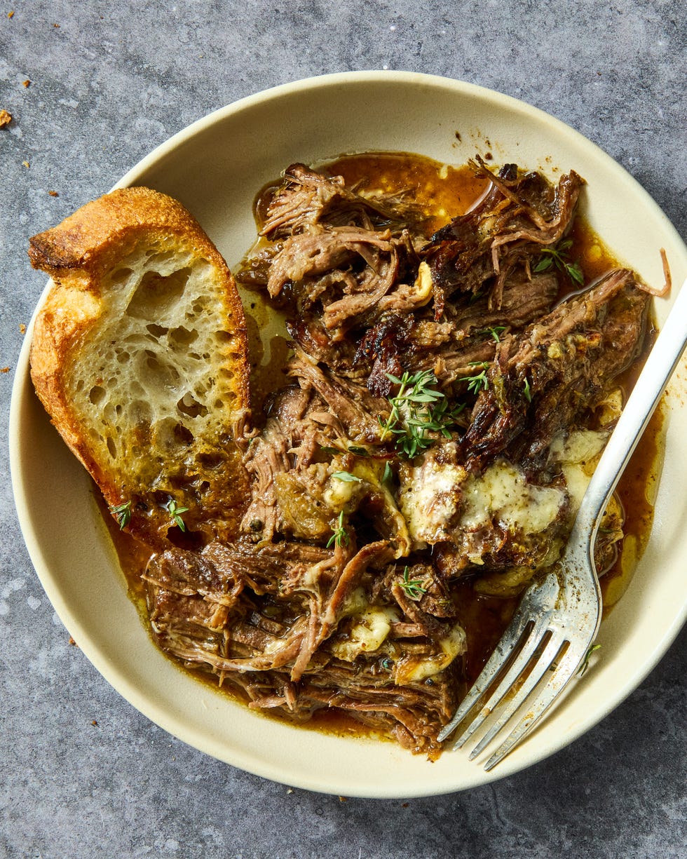 onion seasoned beef is nestled in a bed of cooked onions, red wine, fresh thyme, and beef broth, then braised until ridiculously tender, shredded, and topped with nutty, salty gruyere cheese
