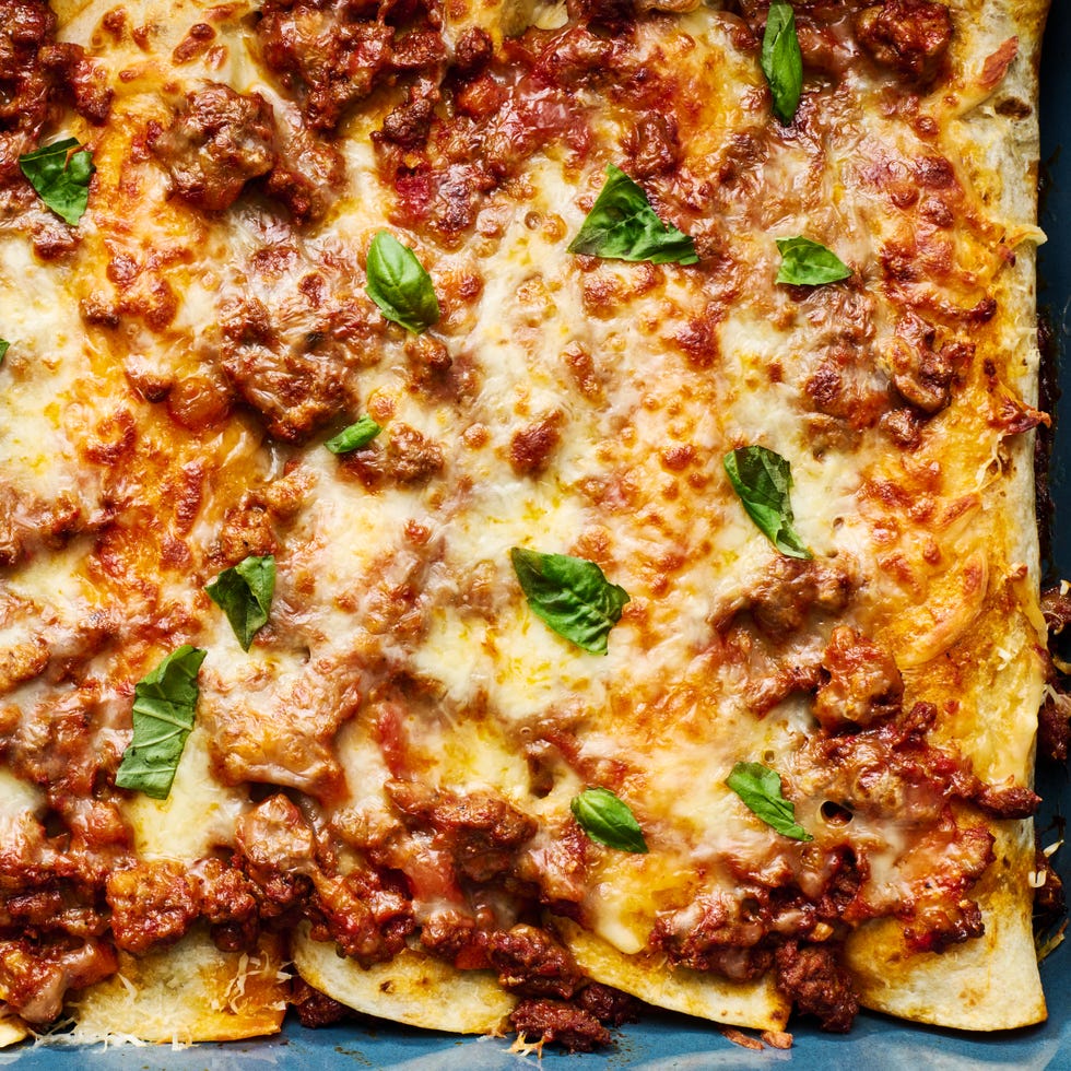 saucy beef bolognese, and herby ricotta rolled into flour tortillas and topped with more bolognese mozzarella and parmesan then baked until bubbly and perfect