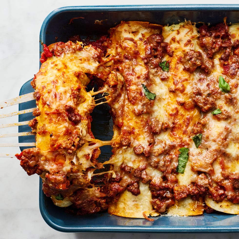 saucy beef bolognese, and herby ricotta rolled into flour tortillas and topped with more bolognese mozzarella and parmesan then baked until bubbly and perfect