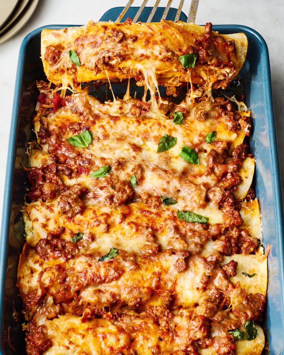 saucy beef bolognese, and herby ricotta rolled into flour tortillas and topped with more bolognese mozzarella and parmesan then baked until bubbly and perfect