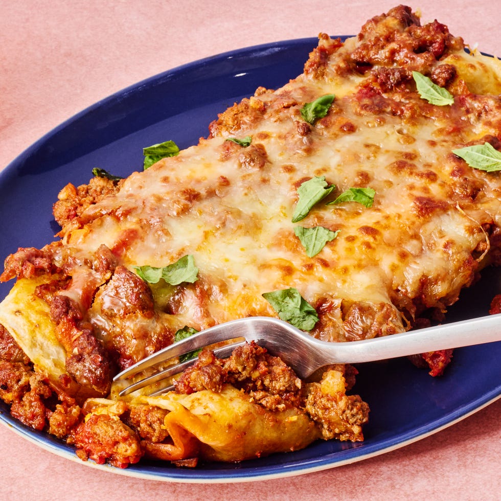 saucy beef bolognese, and herby ricotta rolled into flour tortillas and topped with more bolognese mozzarella and parmesan then baked until bubbly and perfect