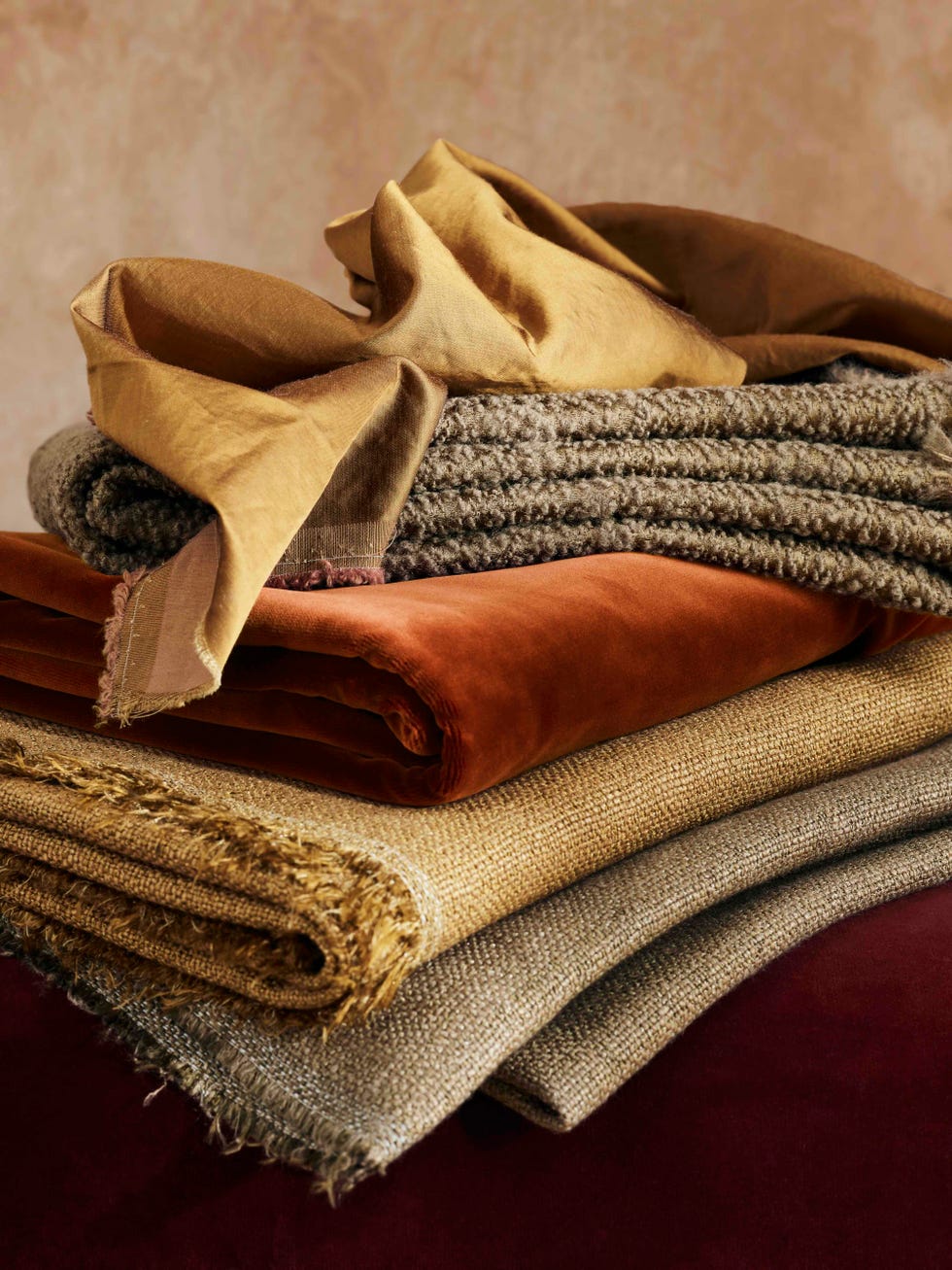 assorted fabric swatches stacked in various colors and textures