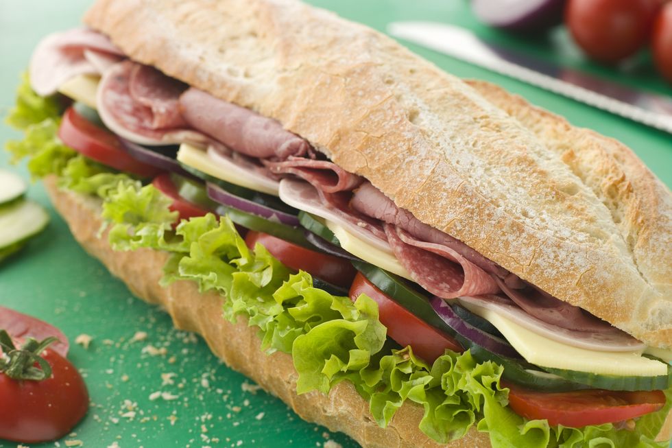 deli sub sandwich on a chopping board