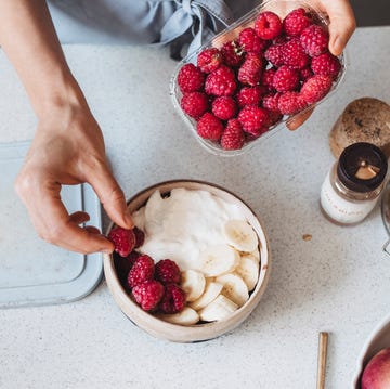 delicious bowl of rolled oats with fruit, all homemade by a woman wearing blue