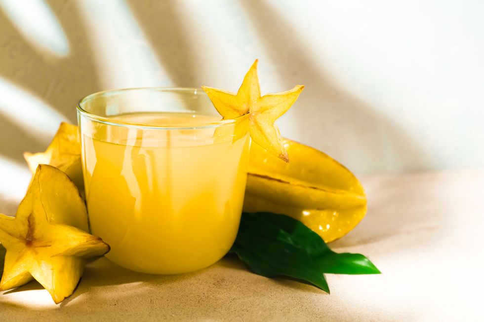 delicious carambola juice in glass on light table