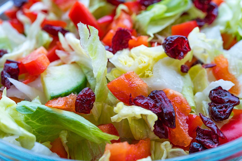 Delicious lettuce salad with cucumbers, red peppers and...