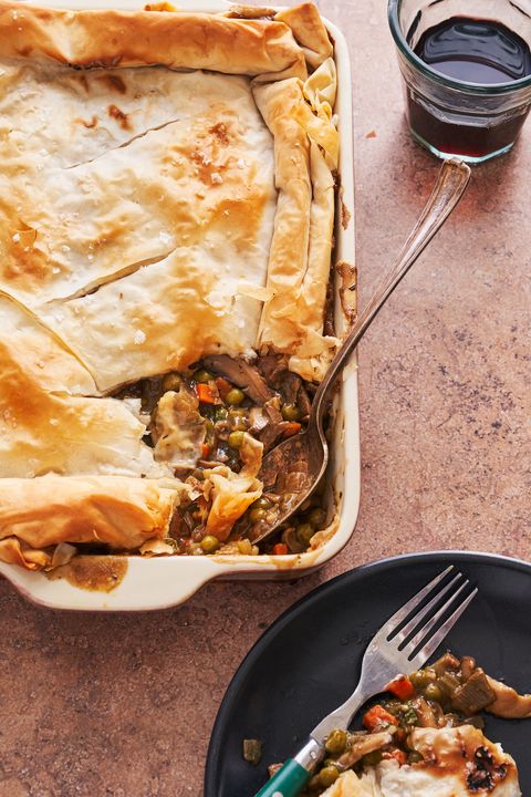 saucy vegan mushroom pot pie with phyllo dough crust, first portion scooped onto a plate