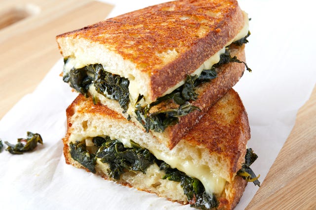 Kale Grilled Cheese - Delish.com grilled cheese cut in half, loaded with melty white cheese and braised kale