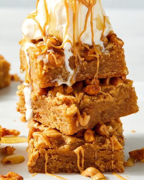 stack of honey and peanut butter blondies topped with melty ice cream and honey