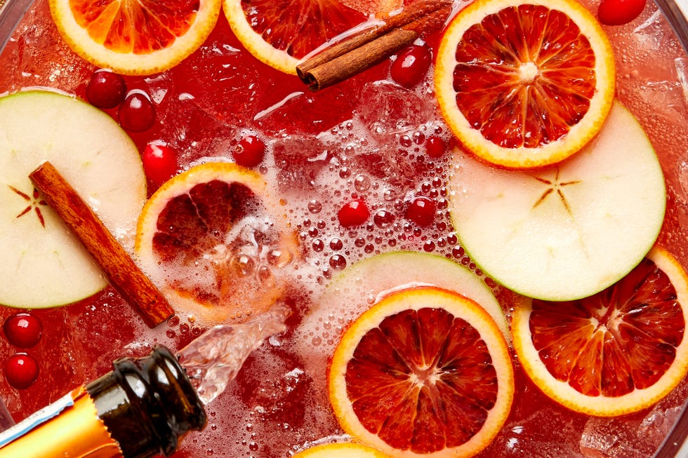 christmas punch, holiday punch bowl with apples, oranges, cranberries, cinnamon, prosecco, cocktail