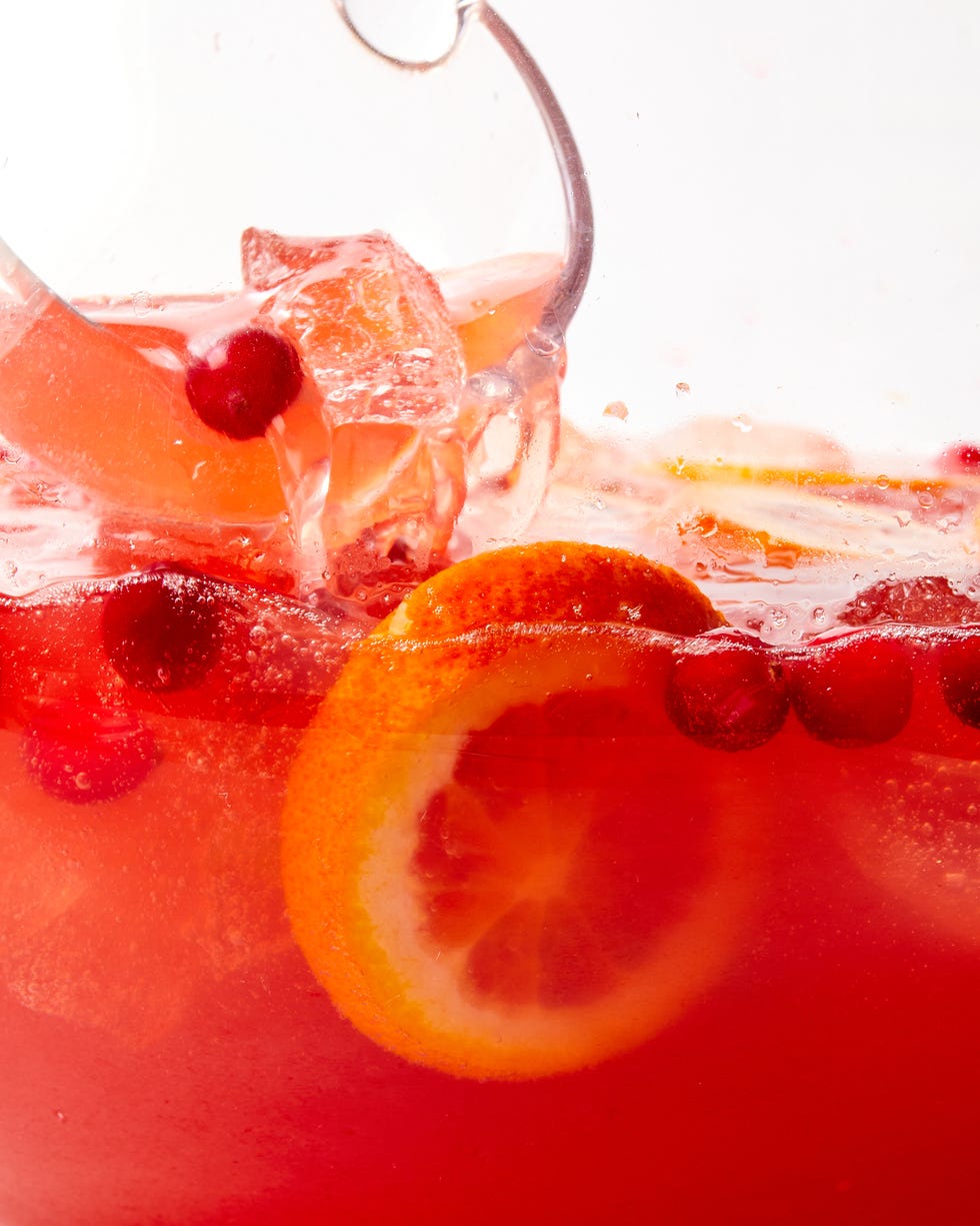 christmas punch, holiday punch bowl with apples, oranges, cranberries, cinnamon, prosecco, cocktail