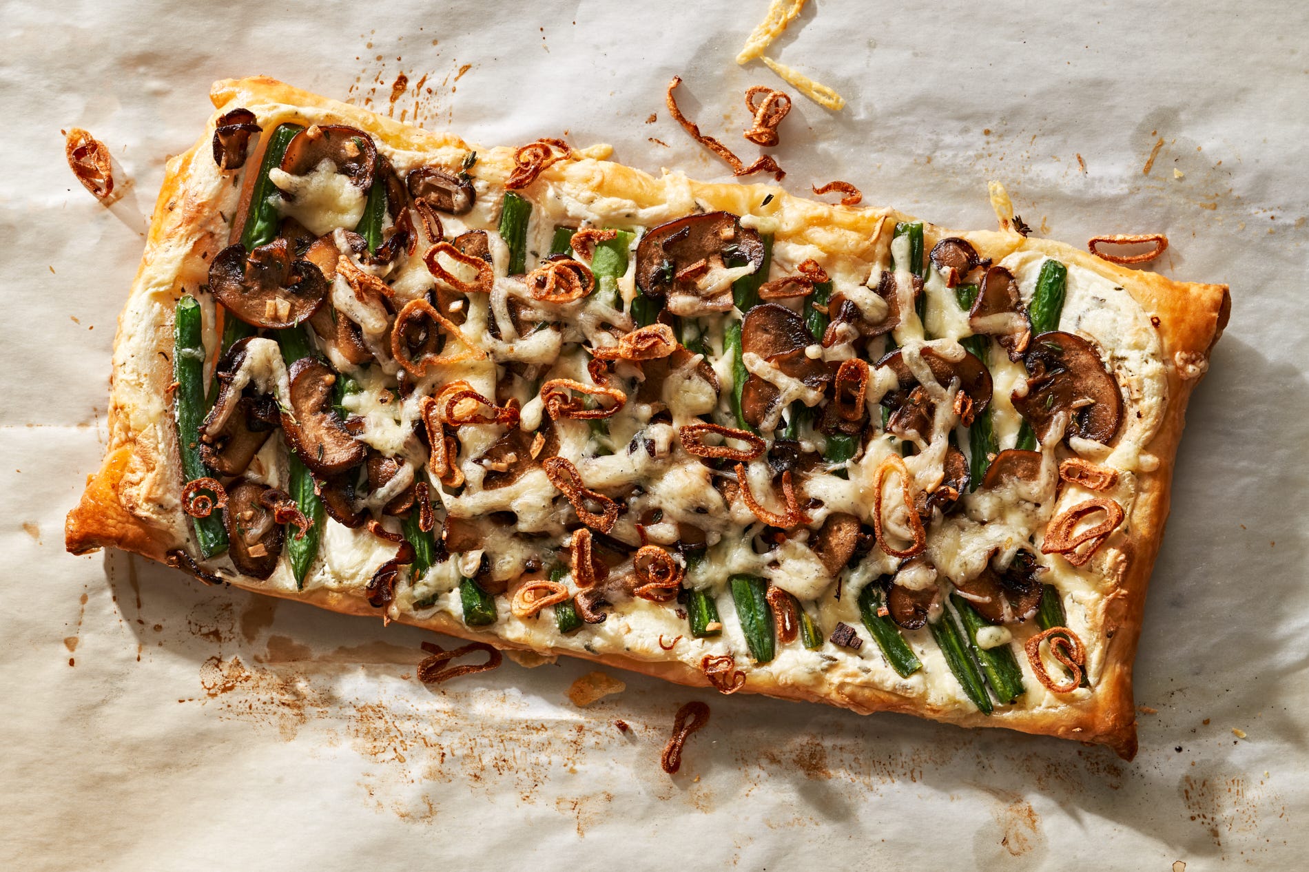 This Cheesy Green Bean & Mushroom Tart Is All About The Crispy Shallot Topping