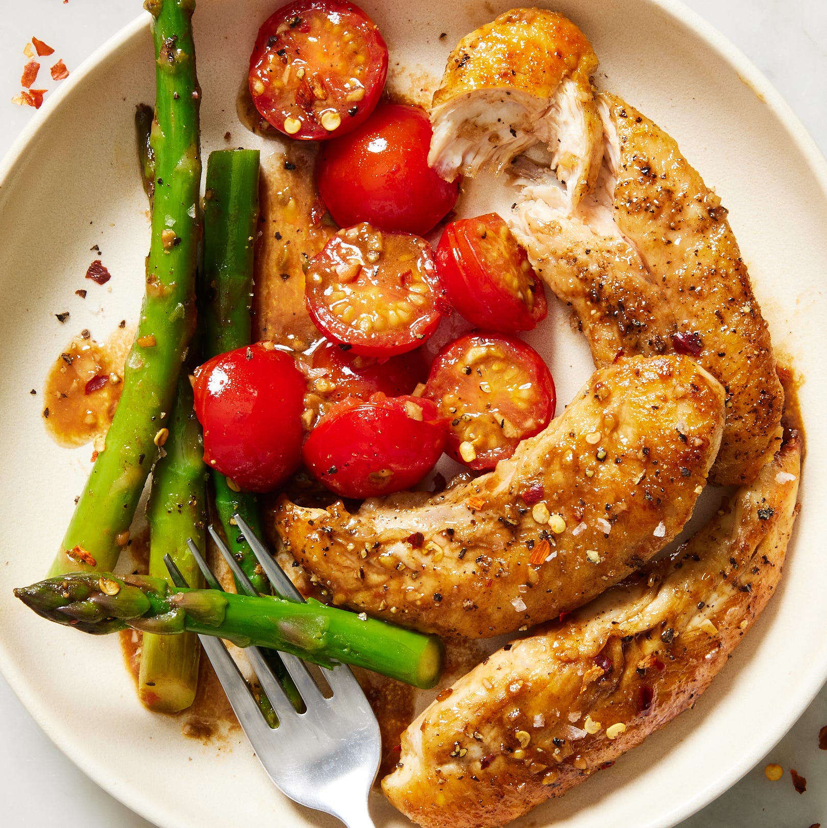 Balsamic chicken, cherry tomatoes and asparagus in this one-pan dinner to welcome spring.