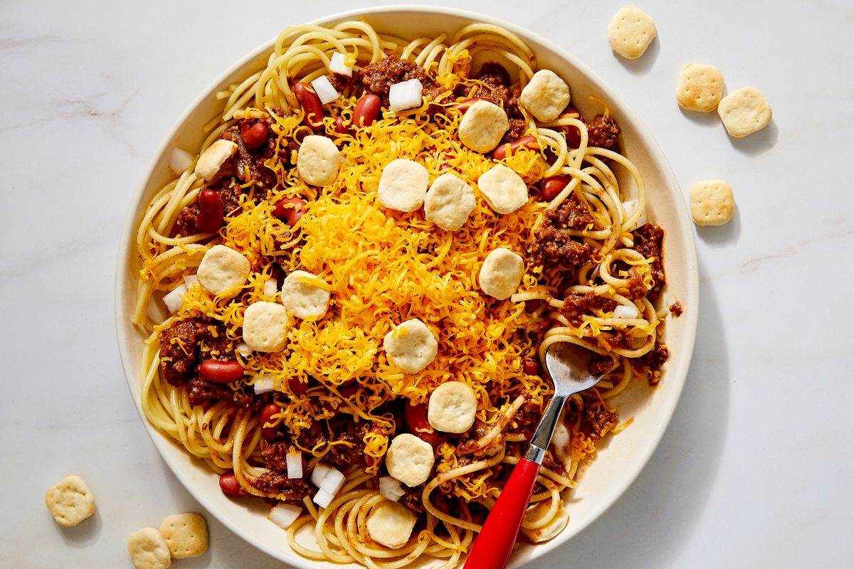 cincinnati chili with cheddar, kidney beans, onion, and oyster crackers