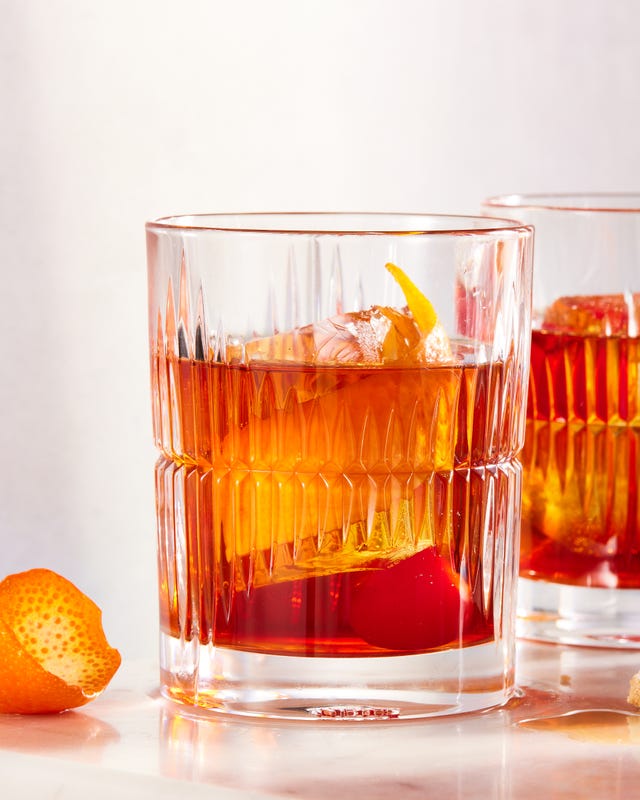 bourbon old fashioned with demerara sugar, bitters, maraschino cherry, and orange peel