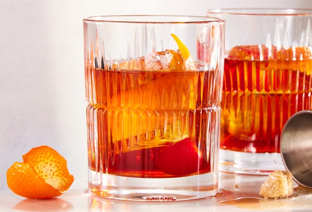 bourbon old fashioned with demerara sugar, bitters, maraschino cherry, and orange peel