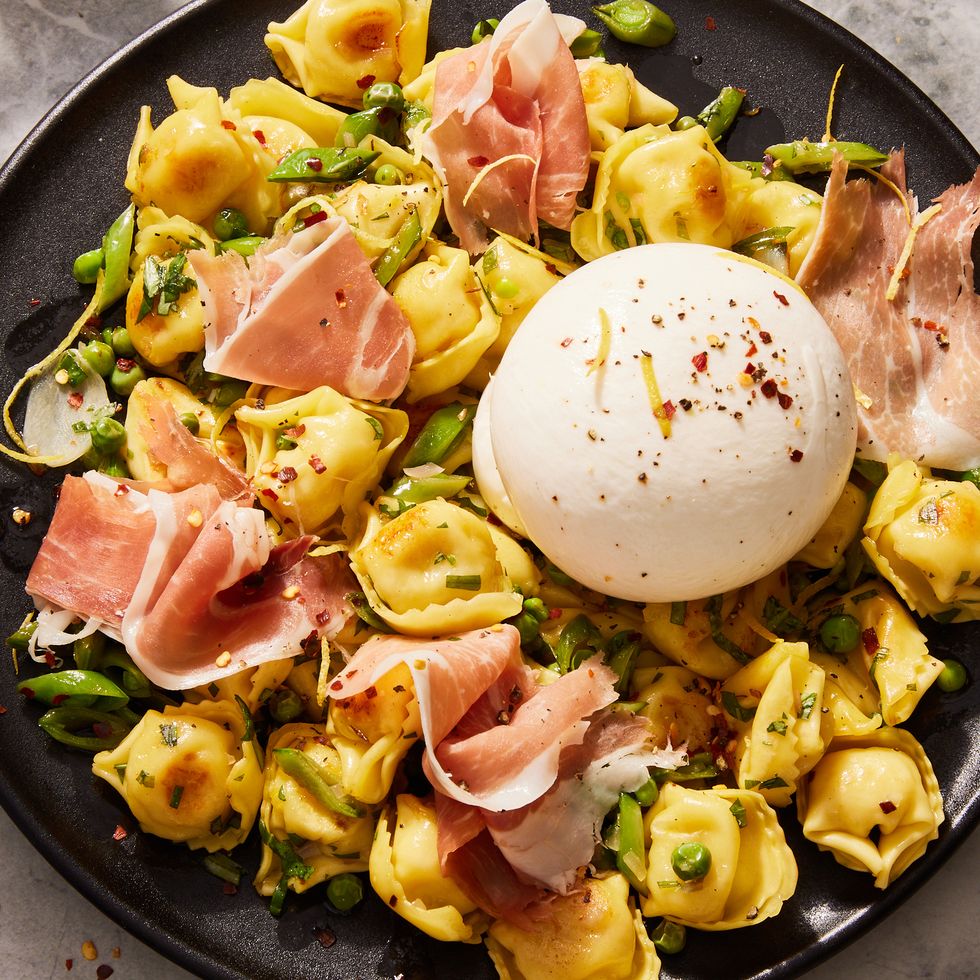 butter toasted cheese tortellini with snap peas, spring peas, prosciutto, creamy burrata, lemon, and red pepper flakes