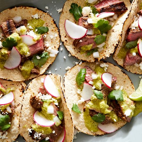 marinated, grilled skirt steak, piled into a corn tortilla with salsa verde, cilantro, red onion, cotija, and radish
