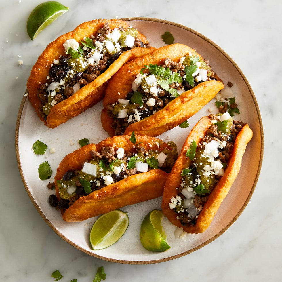 chalupas with ground beef beans onions cojita and salsa verde