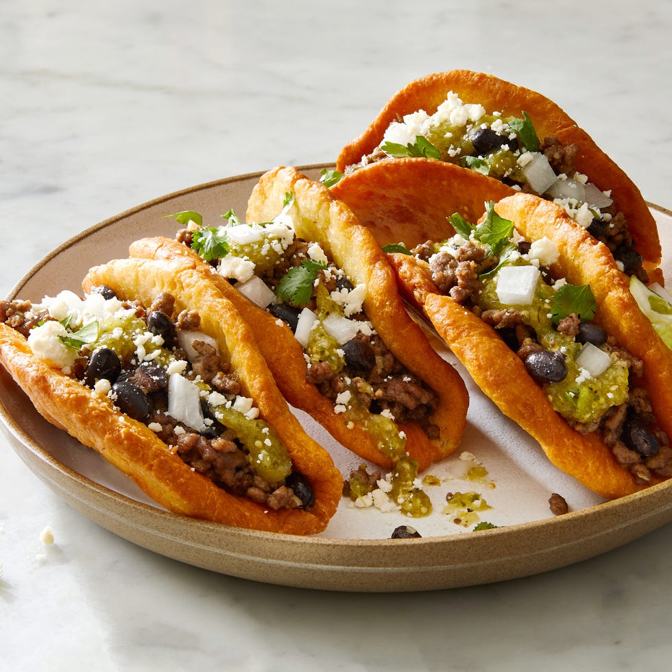 chalupas with ground beef beans onions cojita and salsa verde