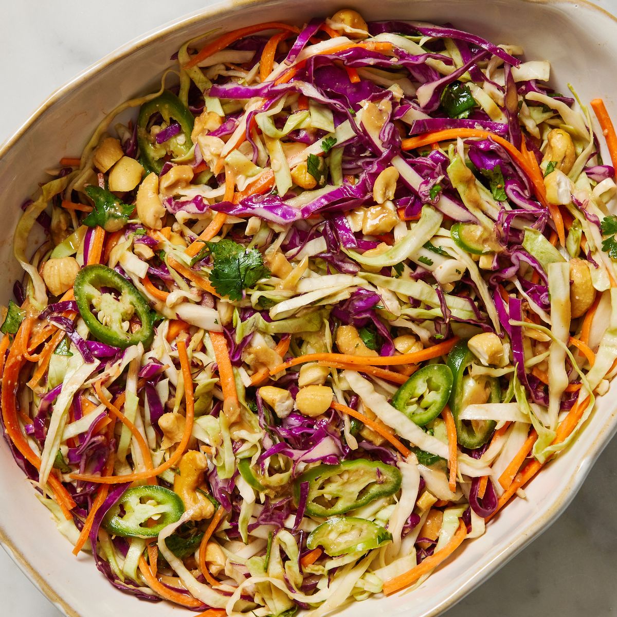 thai style slaw with green red cabbage carrot jalapeno cilantro basil peanut soy sesame dressing and peanuts