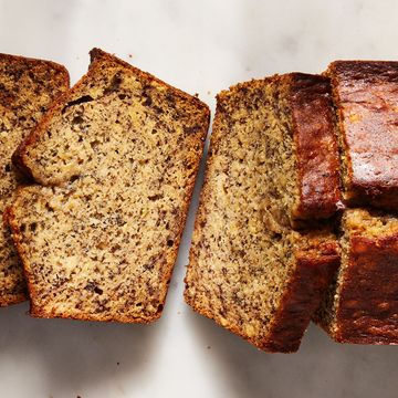 banana bread loaf sliced on a white surface
