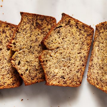 banana bread loaf sliced on a white surface