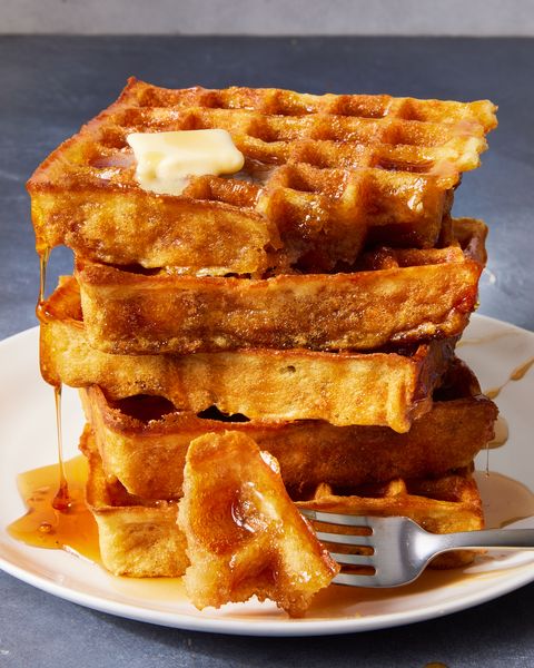 square classic waffles topped with butter and drizzled with maple syrup